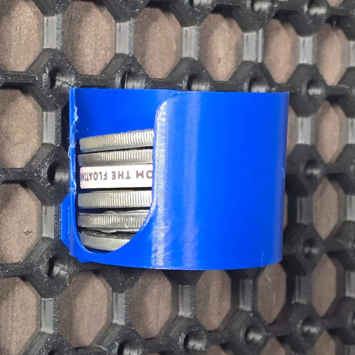 Blue challenge coin holder and dispenser mounted on a Multiboard panel